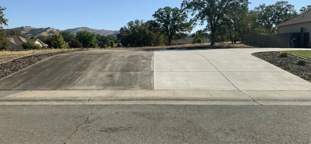 Before and after curved driveway cleaning in Folsom showing dirty and restored concrete
